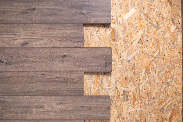 Laminate floor on wood osb background texture. Wooden laminate floor and chipboard background with copy space