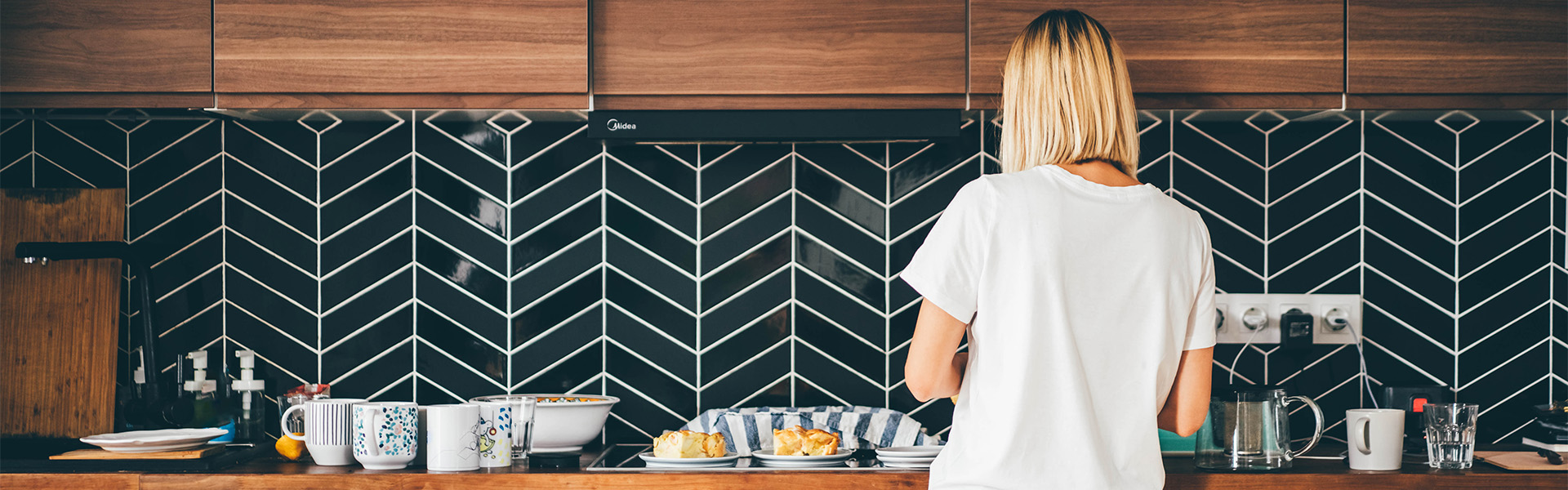 Woman making herself breakfast in her modern home kitchen