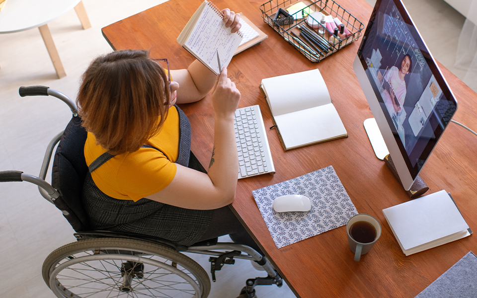 Woman in wheel chair working at a desk